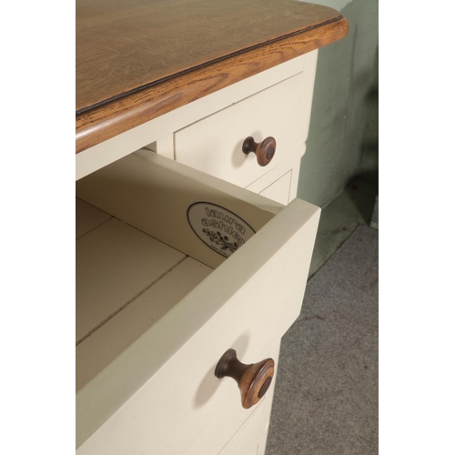 507 - A Laura Ashley pine and oak cream painted tall boy, with six drawers and cupboard door. Height: 136c... 