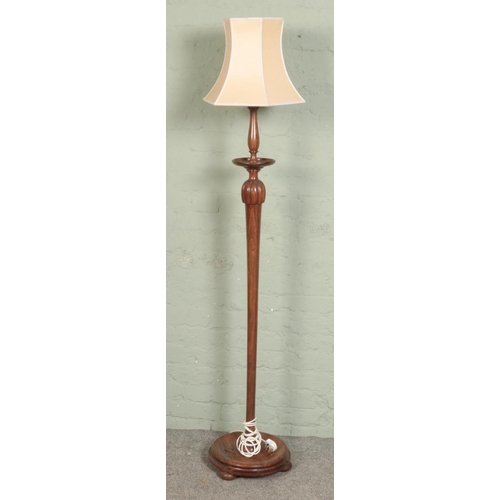 518 - A standard lamp with turned column and circular base on pad feet