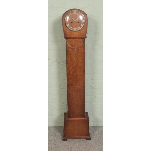 520 - A carved oak granddaughter clock, with Smiths Enfield movement; the face bearing Arabic numeral mark... 