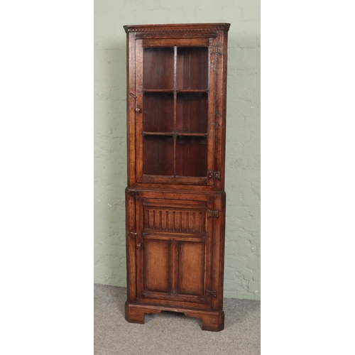 522 - A Titchmarsh & Goodwin style oak corner cupboard, with glazed top above cupboard door. Height: 179cm... 