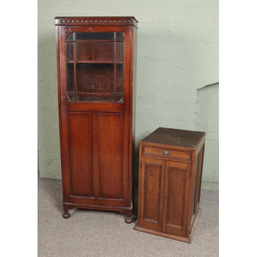 528 - An oak single tall cupboard with half glazed door with gramophone cabinet base.