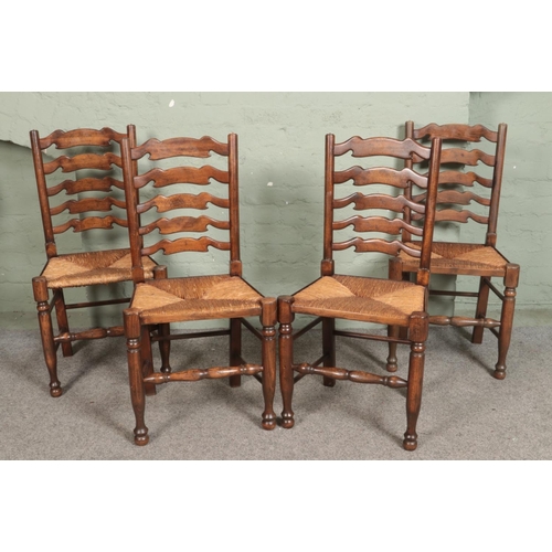 531 - A set of four ladder back rush seat dining chairs.