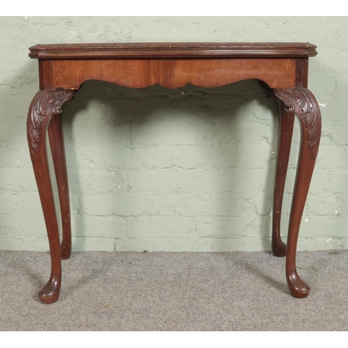 550 - A Maple & Co mahogany fold over card table. Raised on cabriole supports. Bearing Maple Quality label... 