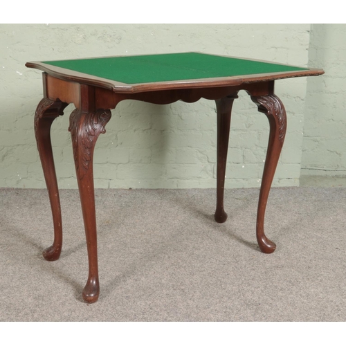 550 - A Maple & Co mahogany fold over card table. Raised on cabriole supports. Bearing Maple Quality label... 