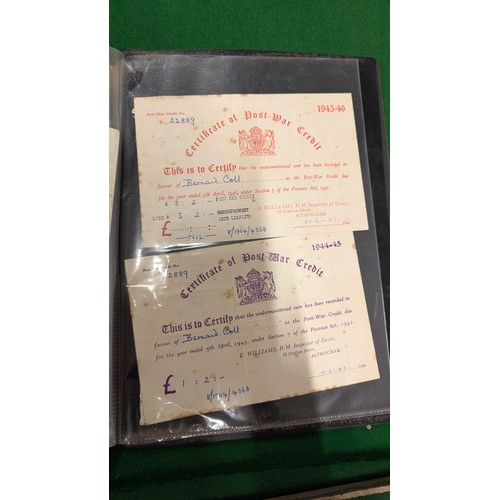 455 - A folder holding a collection of war time militaria including Hitler Youth documents, cuff titles, f... 