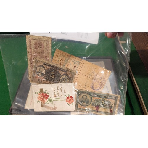 455 - A folder holding a collection of war time militaria including Hitler Youth documents, cuff titles, f... 