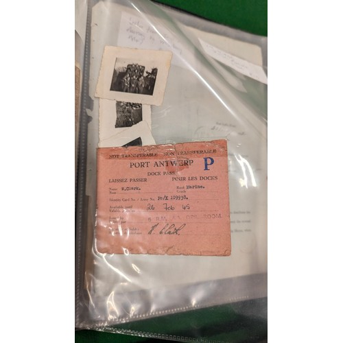 455 - A folder holding a collection of war time militaria including Hitler Youth documents, cuff titles, f... 