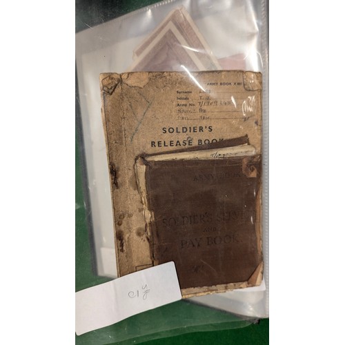 455 - A folder holding a collection of war time militaria including Hitler Youth documents, cuff titles, f... 