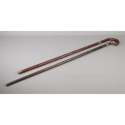 109 - Two white metal mounted walking sticks, including silver collared example.