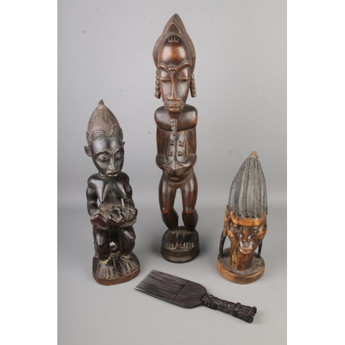 118 - A collection of tribal figures including a tribal comb.