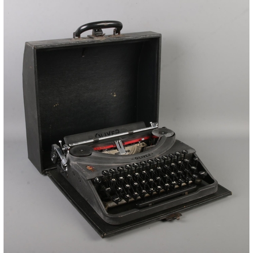 147 - A mid-century Oliver portable typewriter, in case. Bears Oliver Cromwell figure to the body.