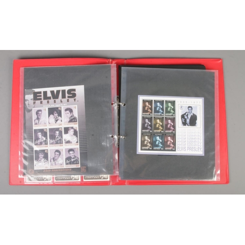 159 - An album containing Disney and Elvis Presley stamps and collectables to include several stamp sheets... 