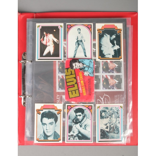 159 - An album containing Disney and Elvis Presley stamps and collectables to include several stamp sheets... 