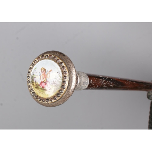 16 - An antique umbrella with silver and enamel top