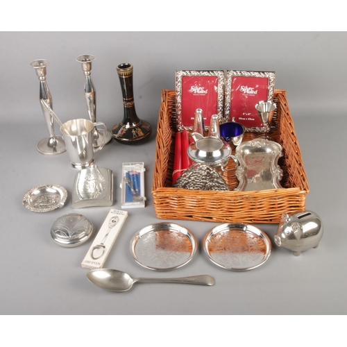 162 - A tray of mostly assorted silver plate and pewter items to include candle sticks, photo frame, embos... 