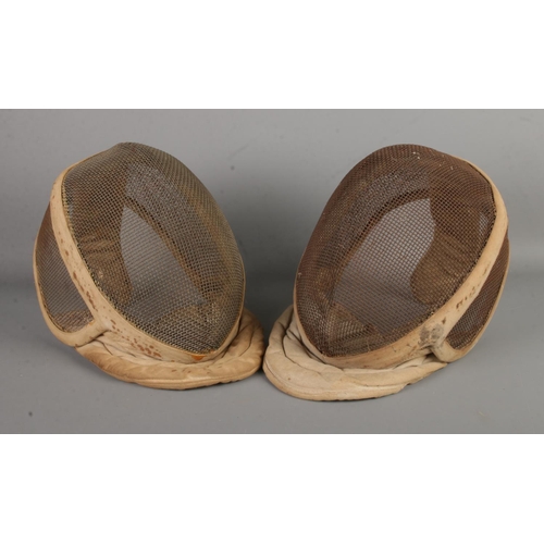 164 - Two vintage fencing masks, labelled for Leon Paul, London.