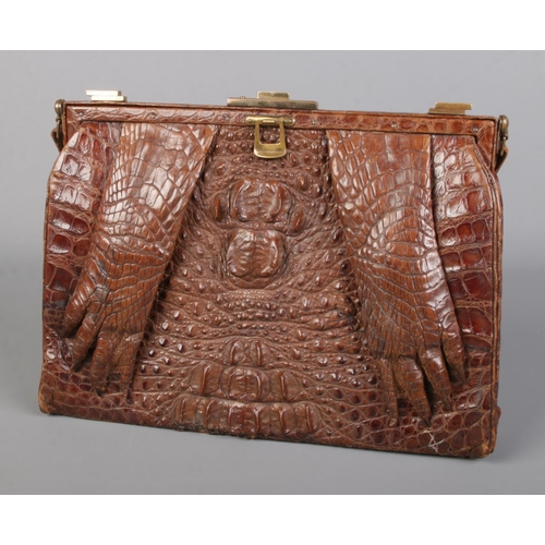 19 - A vintage ladies Crocodile skin purse featuring leather lining and claws to front. 29cm x 21cm. CANN... 