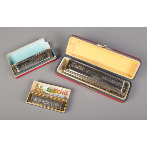 24 - A collection of vintage harmonicas including a Hohner Echo Super Vamper, The 64 Chromonica and The B... 