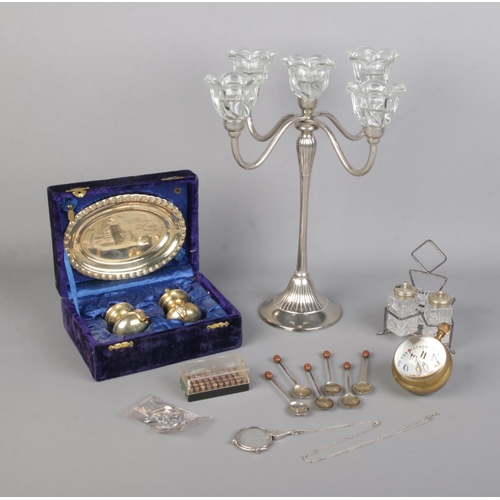 28 - A quantity of collectables, to include Elgin bullseye desk clock, silver plated candelabra, boxed cr... 