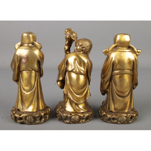 4 - Three Chinese bronze figures of sages, raised on stepped hardwood stand. Each figure bearing charact... 