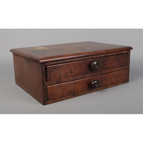 43 - A tabletop set of two drawers containing a collection of costume jewellery, mainly yellow metal exam... 