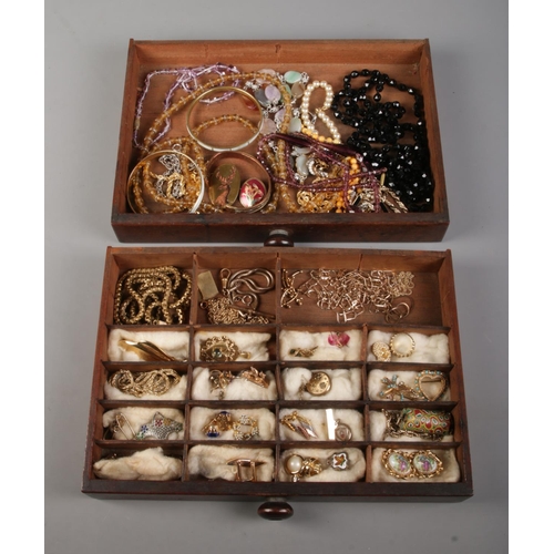 43 - A tabletop set of two drawers containing a collection of costume jewellery, mainly yellow metal exam... 