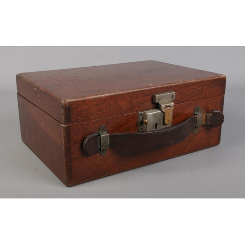 46 - A hinged mahogany case containing a collection of mainly white metal items. To include silver handle... 