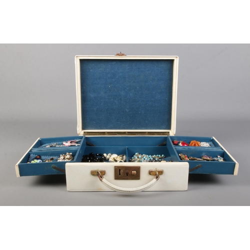 49 - A white cantilever jewellery box containing a collection of vintage jewellery. Includes an assortmen... 