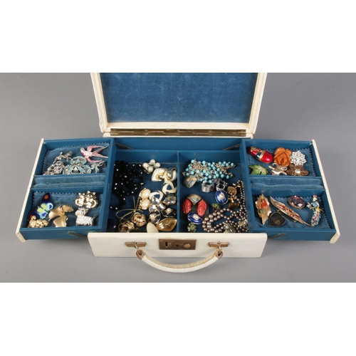 49 - A white cantilever jewellery box containing a collection of vintage jewellery. Includes an assortmen... 