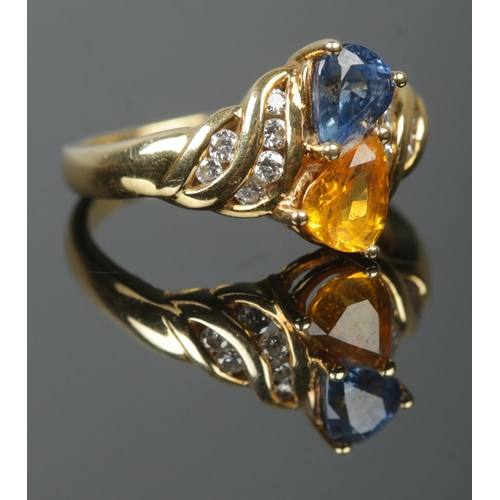 An 18ct Gold Blue and Yellow Sapphire and Diamond ring. Bearing Birmingham import mark and dated for 1994. Size M½. The total points inscribed to the inside of the band (Diamond: 23 points, Blue Sapphire: 85 points and Yellow Sapphire: 86 points). Total weight: 5.1g
