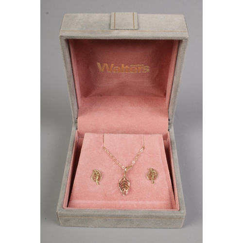 396 - A matching 10k gold necklace and earrings set with leaf pendant design.

1.4g