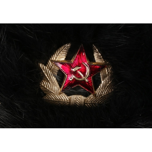 60 - A Russian Soviet Union black fur Ushanka hat bearing hammer and sickle crest to front.