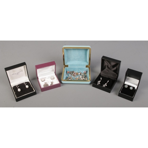 410 - A large collection of silver mounted earrings, across five boxes.