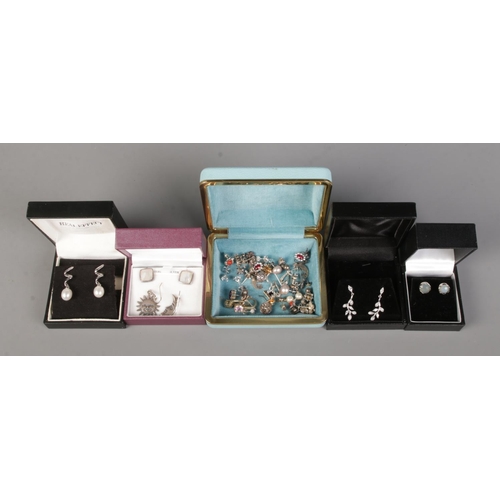 410 - A large collection of silver mounted earrings, across five boxes.