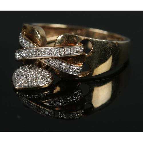 414 - A 9ct gold ring formed as a laced band with heart shaped charm. Size I, 3.47g.