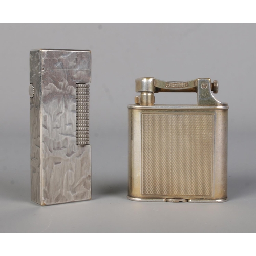 434 - Two vintage Dunhill lighters; a silver plated Rollagas example along with one other.