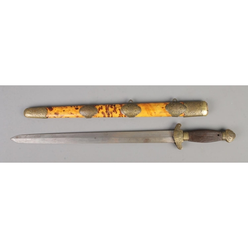 444 - A Chinese Jian short sword featuring ribbed grip, brass pommel and brass mounts on tortoiseshell sca... 