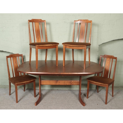 457 - A mid-century G Plan oval extending dining table, with four G Plan chairs.