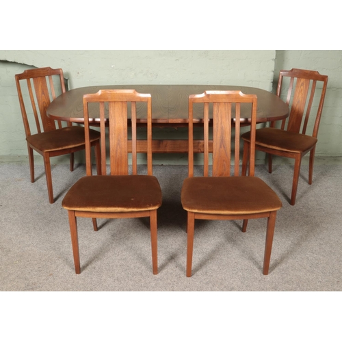 457 - A mid-century G Plan oval extending dining table, with four G Plan chairs.