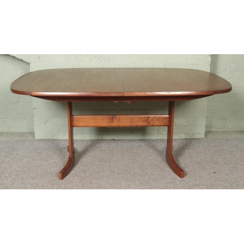 457 - A mid-century G Plan oval extending dining table, with four G Plan chairs.