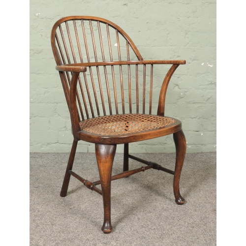 474 - A small ash/elm hoop back Windsor arm chair with bergere seat.