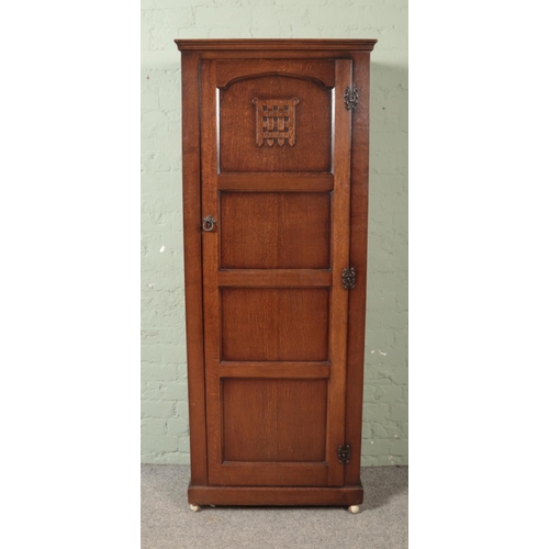 483 - A single door oak wardrobe/hall cupboard with iron gate design to front 

Hx182cm
Wx72cm
Dx43cm