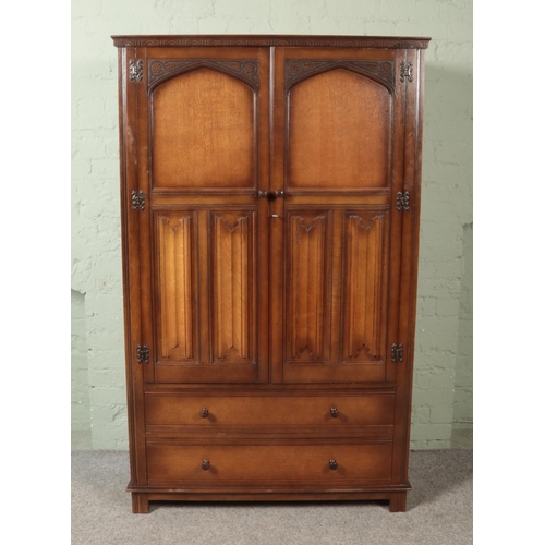 485 - A large oak linen fold panel wardrobe with two lower drawers.

Hx179cm
Wx111cm
Dx48cm