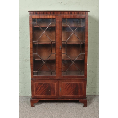 487 - A mahogany two section cabinet, with astragal glazed top. Height: 141cm, Width: 86cm, Depth: 34cm.