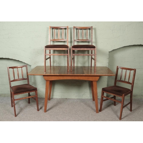 488 - A mahogany extending dining table produced by F.D. Welters, together with four dining chairs with fa... 