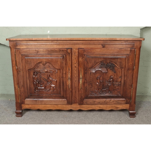 503 - A French oak sideboard with heavily carved panels depicting farming country scenes.

Hx99cm
Wx154cm
... 