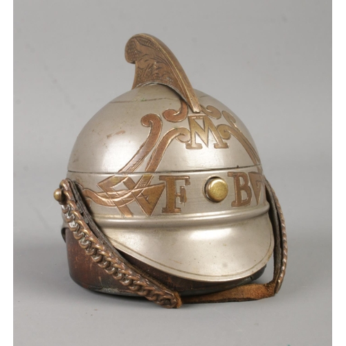 95 - A novelty metal inkwell formed as a Victorian fireman's helmet. With hinged top and inside cover.