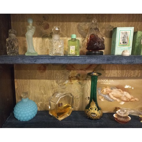 158 - A white painted glazed cabinet housing a large quantity of scent bottles, including vintage examples... 