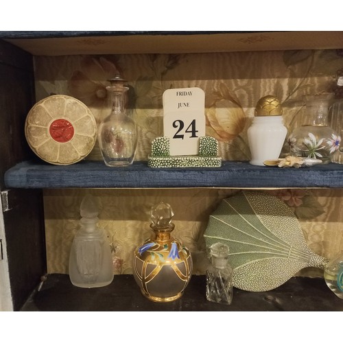 158 - A white painted glazed cabinet housing a large quantity of scent bottles, including vintage examples... 