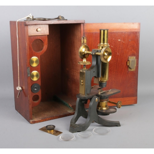 1 - A mahogany cased Negretti & Zambra brass bodied microscope, with adjustable column, lenses and slide... 